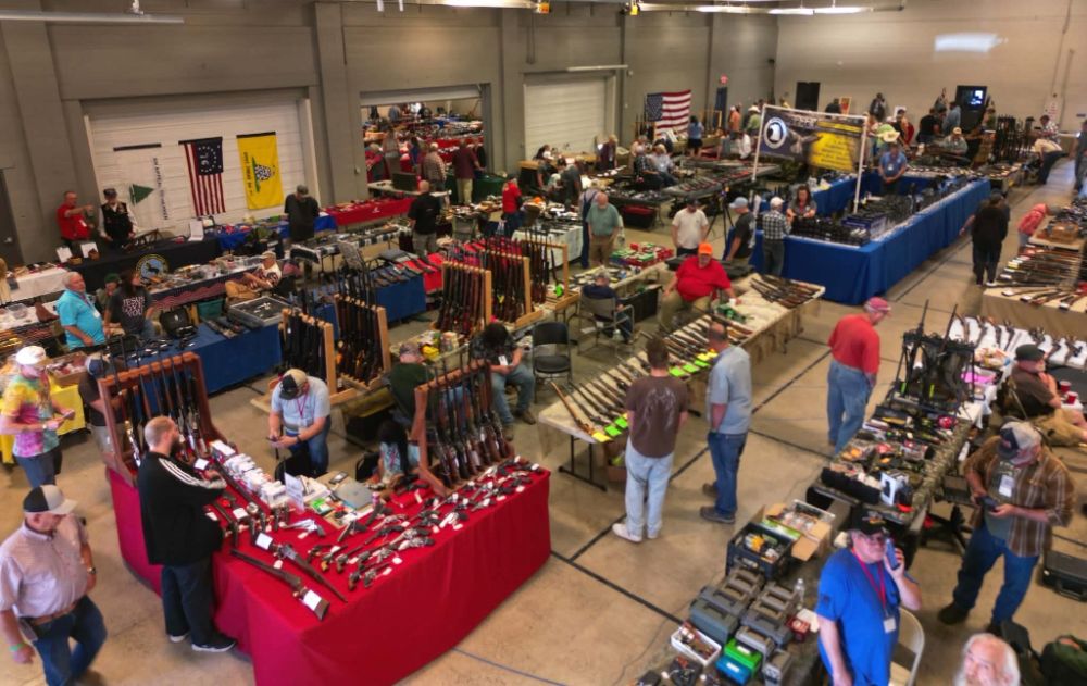 Rows of vendor tables filled with rifles, handguns and militaria at the WWCA gun show in Riverton.
